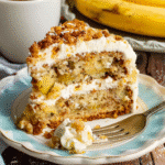 slice of hummingbird cake showing pineapple jam filling and cream cheese frosting