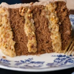 German chocolate cake slice with thick layers of coconut pecan filling